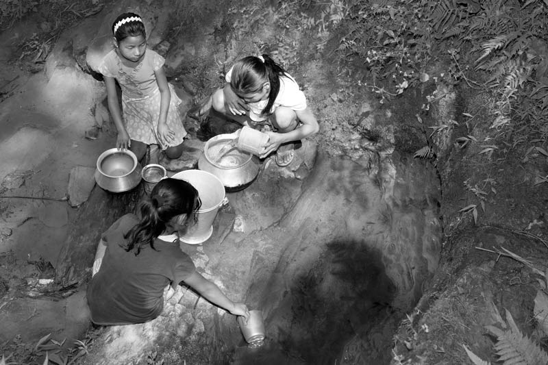 Rural Drinking Water Challenges - Collecting scanty drinking water from an unprotected source near Tirap open-cast coalmine in Makum Coalfield, Tinsukhia district, Assam